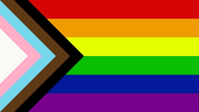 Progress Pride flag, including original rainbow design, trans flag elements and black and brown stripes for racial justice.